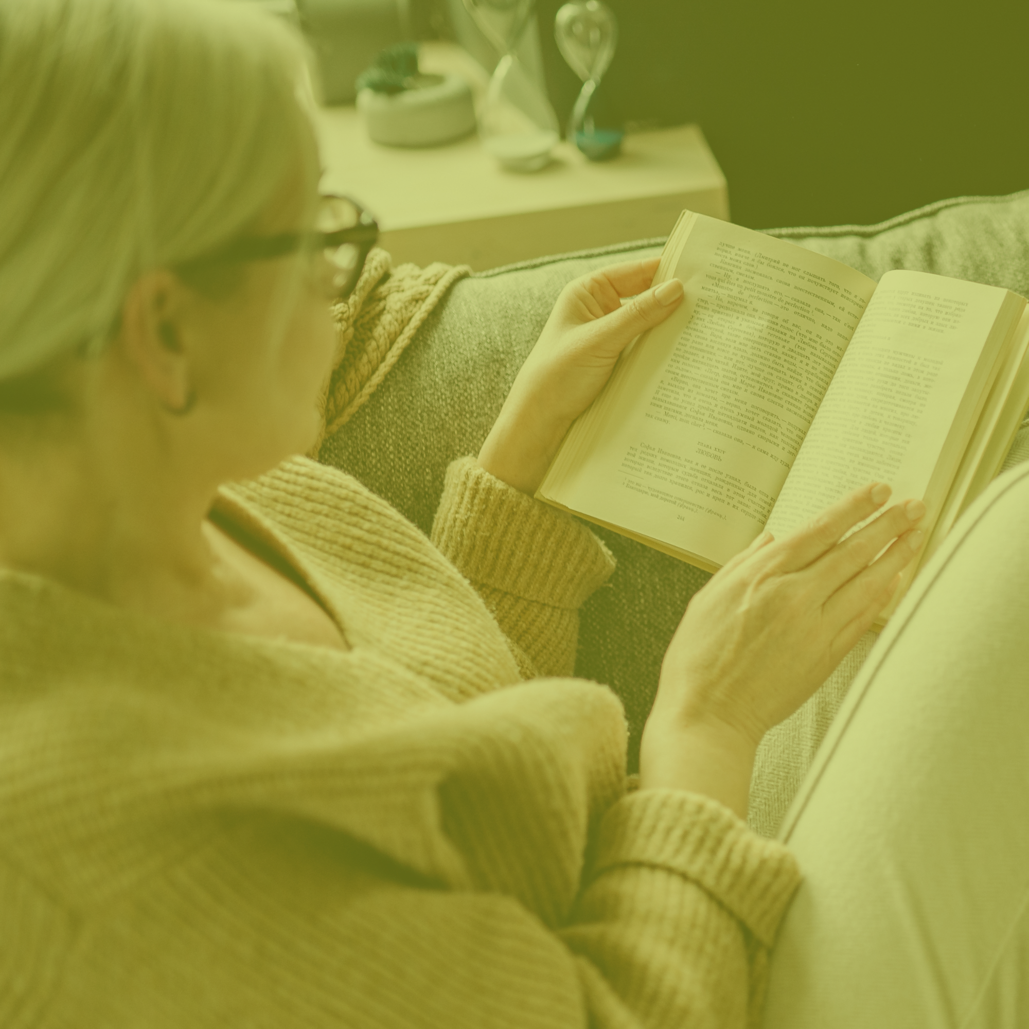 Woman relaxing with the moodtanicals spray while reading.