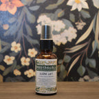 Bottle of Moodtanicals Clean Lift spray with a floral background