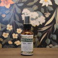 Bottle of Moodtanicals Pineal Sharp on a wooden surface with a floral background